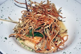 Pan-seared halibut with shoestring potatoes and lemon caper sauce